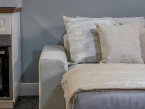 a couch with pillows on it in a room at Pass the Keys Happy Haven Home, West End in Glasgow