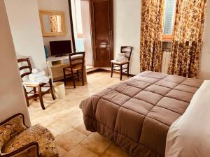 Voodi või voodid majutusasutuse Hotel Le Logge toas