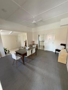 a living room with a dining room table and chairs at The Gabba B&B in Brisbane