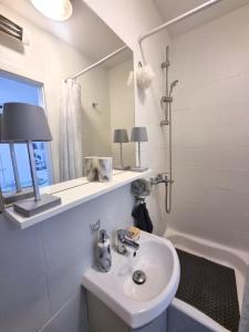a bathroom with a sink and a mirror and a tub at Omiš centar studio apartment in Omiš