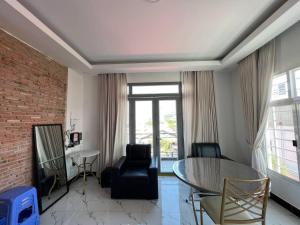 a living room with a glass table and chairs at Jasminsorium in Phnom Penh