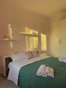 Un dormitorio con una cama grande con toallas. en Navigli Home Metro4-Tram2-Naviglio Grande, en Milán