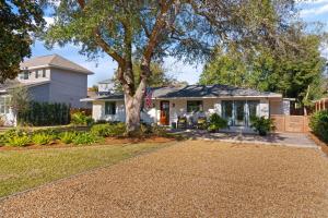 a house with a tree and a driveway at Tranquility - 4318 Tenth Street in Saint Simons Island