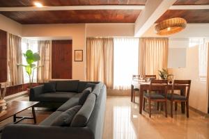a living room with a couch and a table at Heiwa by Hodo stays in Bengaluru