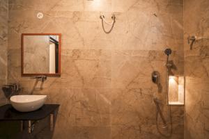a bathroom with a sink and a shower with a mirror at Heiwa by Hodo stays in Bengaluru +82 photos