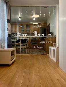 a kitchen and dining room with wood floors and a table at V A z A T A apartment in Ruse +16 photos