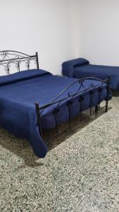 a blue bed and a couch in a room at Terrazza sul mare in Crotone