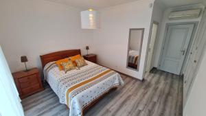 a bedroom with a bed and a dresser and a mirror at VILLA DO LIMAO in Tavira +55 photos