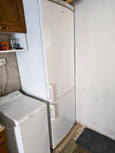 a white refrigerator in a kitchen next to a stove at Kimon Penthouse in Thessaloniki +9 photos