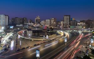 a city at night with traffic on a highway at Holidays Express Hotel in Cairo