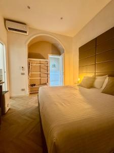 a bedroom with a large bed and a closet at NapoliOn - Luxury Apartment in Naples