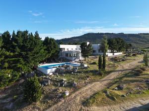 an aerial view of a house with a swimming pool at Elegance Hotel Tandil in Tandil