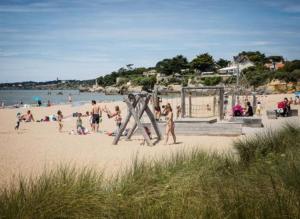 a group of people on a beach with a playground at Maison 43m2 meublée 200m plage in La Bernerie-en-Retz