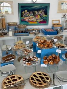 a table with various pastries and pies on display at Hotel Albatros in Ischia