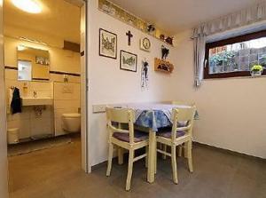 a kitchen with a table and chairs and a bathroom at Haus Sütterlin in Neuenburg am Rhein