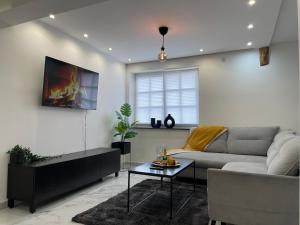 a living room with a couch and a table at ADVENTURE LuxusApartment in Wetzlar