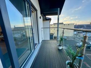 an apartment balcony with a view of a building at Gwel Y Bae-2 Bed-en-suite-Lift-Pet friendly in Trearddur