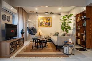a living room with a couch and a tv at The Nile Vintage Haven in Cairo