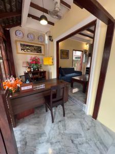 a living room with a desk and a couch at Chaluenxay Legend Hotel in Luang Prabang