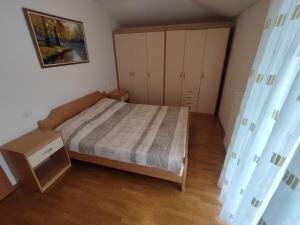 a small bedroom with a bed and a cabinet at Apartma Marea in Izola