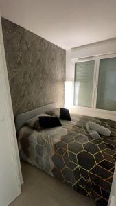 a bedroom with a large bed in a room at BY NEPTUNE - Appartement Disneyland Paris in Chessy