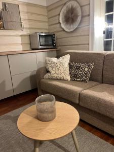 a living room with a couch and a coffee table at Sentrum Lillesand unique accommodation in Lillesand +20 photos