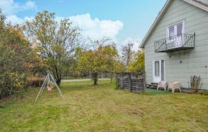 a yard next to a house with a swing at Stunning Home In Charlottenberg in Charlottenberg