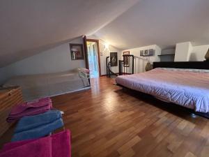 a bedroom with a bed and a wooden floor at Rosemary 2 in Fano