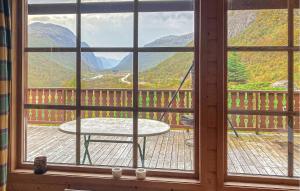 a window with a table and a view of mountains at Amazing Home In Dirdal With Wifi in Dirdal +9 photos