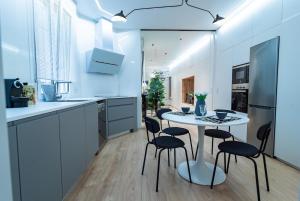 a kitchen with a white table and chairs at Carmen 6 by ARoom in León
