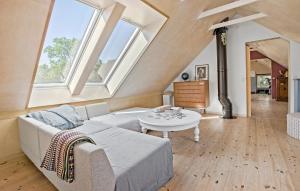 a living room with a couch and a table at 4 Bedroom Beautiful Home In Knebel in Knebel