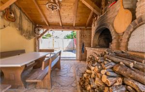 a dining room with a table and a fireplace at 1 Bedroom Cozy Apartment In Kakma in Kakma