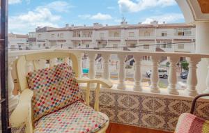a balcony with a chair and a view of a building at Amazing Apartment In Torrevieja in Torrevieja