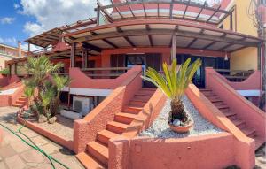 a house with stairs and plants in front of it at 2 Bedroom Beautiful Home In Castelsardo in Castelsardo