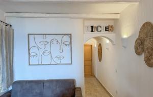 a living room with a couch and a picture on the wall at 2 Bedroom Beautiful Home In Castelsardo in Castelsardo