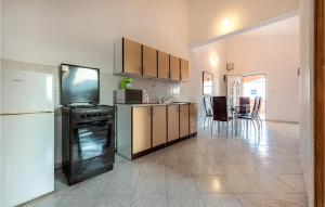 a kitchen with a stove and a refrigerator at Two-Bedroom Apartment In Vir in Vir