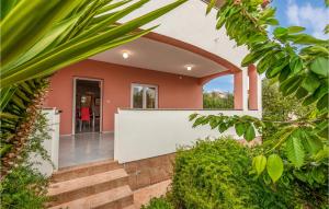 a home with an archway and stairs leading to a house at Two-Bedroom Apartment In Vir in Vir