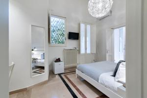 Łóżko lub łóżka w pokoju w obiekcie InCentro Comfort Suite - Lecce Selection