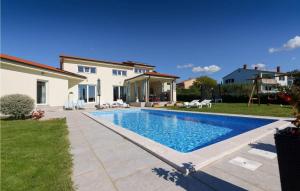 a house with a swimming pool in a yard at Villa Landa in Labinci