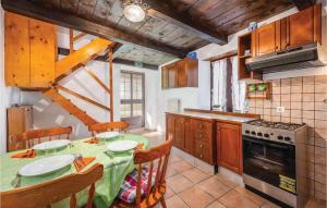 a kitchen with a table and chairs and a stove at 1 Bedroom Amazing Home In Bacva in Bačva