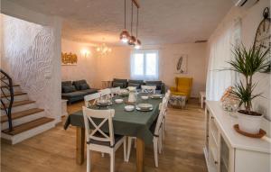 a dining room and living room with a table and chairs at Villa Junona in Kras +6 photos