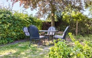 four chairs and a table in a garden at Zeeuwse Parel in Scherpenisse +11 photos