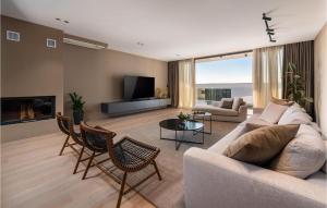 a living room with a couch and chairs and a tv at Nice Home In Pula With Kitchen in Štinjan