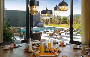 a table with food on it in front of a pool at Nice Home In Pula With Kitchen in Štinjan +42 photos