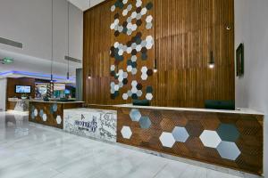 a lobby with a reception desk and a wall with a bunch of spheres at Hotel 430 in Gaborone +34 photos