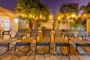 a group of chairs and tables on a patio at night at Rio das Pedras Thermas Hotel in Caldas Novas