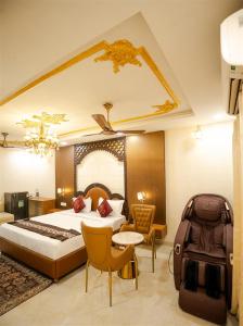 a hotel room with a bed and a suitcase at RAJWADA RESORT & HOTEL in Raipur