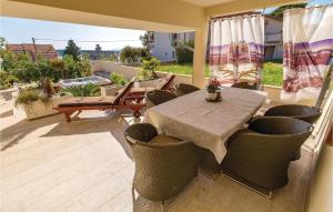 a patio with a table and chairs on a balcony at 4 Bedroom Amazing Home In Barbat in Barbat na Rabu