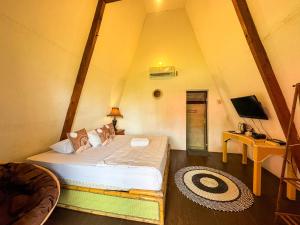 a bedroom with a large bed in a tent at Lovina Krui Surf in Biha