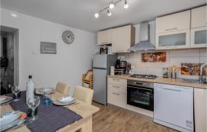 a kitchen with a table and a dining room at 2 Bedroom Stunning Home In Bregi in Breza